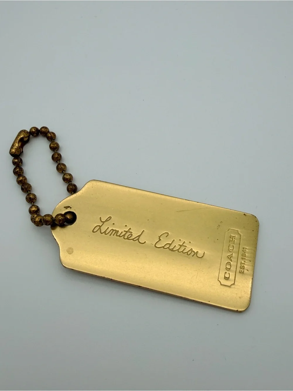 Coach engraved brass